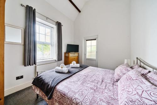 a bedroom with a bed with two towels on it at Southover Beach in Woolacombe