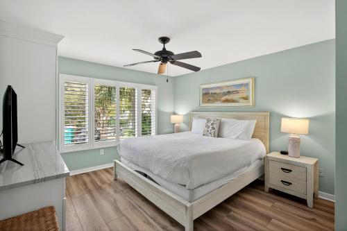a bedroom with a bed and a ceiling fan at SG8A: 8A Seagrove Villa in Isle of Palms