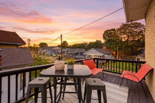 a patio with a table and chairs on a deck at Riverview Escape in Walkable Historic District in Jeffersonville