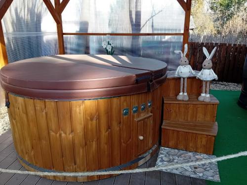 a hot tub in a gazebo with two rabbits on it at BékaLak Vendégház in Ráckeve