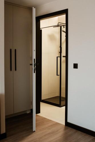 a glass door with a mirror in a room at Piano Property Rental Wrocław in Wrocław