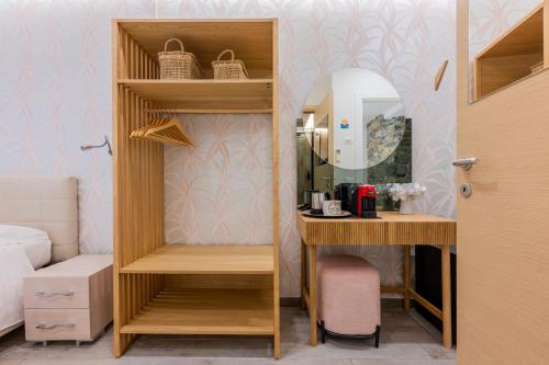 a room with a desk and a shelf with a mirror at 5 Terre Lodge in La Spezia