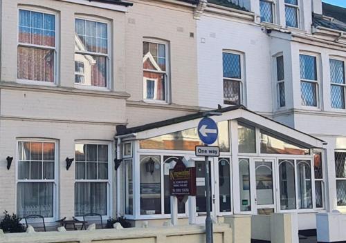 a building with a street sign in front of it at Kingswinford Guest House with Free Parking in Paignton