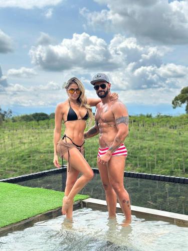 a man and a woman standing in the water at Belvedere Suite Campestre in Alcalá