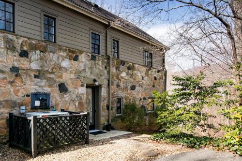 an old stone house with a stone wall at The Forest Door - Studio Suite in Stone Cottage in Tryon