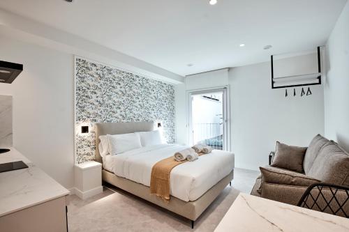 a bedroom with a bed and a couch and a chair at Agora Palas in Palas de Rei