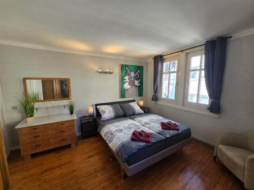 a bedroom with a bed and a dresser and a mirror at Appartement Neckartal in Hirschhorn