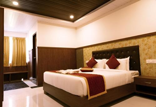 a bedroom with a large bed in a room at Hotel Orcella in Tirupati