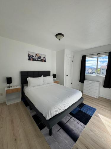 a bedroom with a bed and a window at Cozy blue house in Salt Lake City