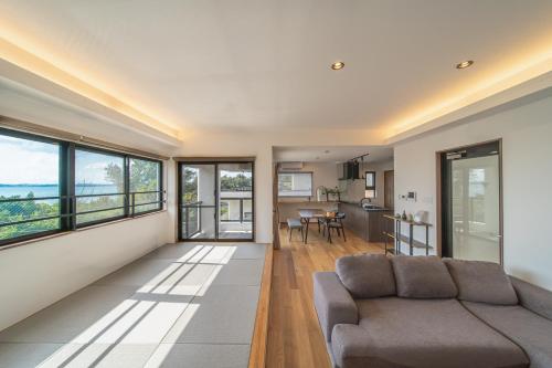 a living room with a couch and a table at LAGUNA OKINAWA Beachfront YAKA in Kin