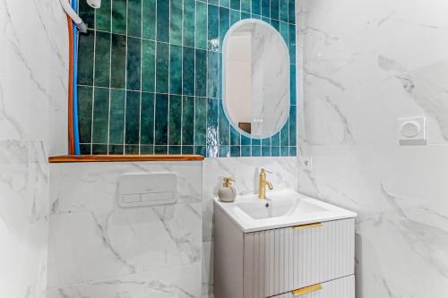 a white bathroom with a sink and a mirror at Sublime brand-new studio with air conditioning in Plaisance-du-Touch