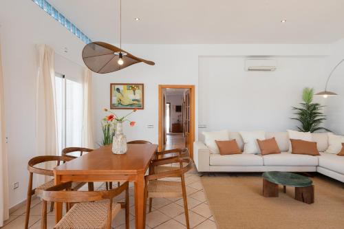 a living room with a table and a couch at New! Villa Lina in Santa Gertrudis de Fruitera