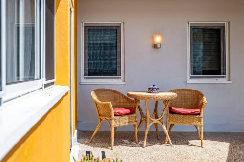 two chairs and a table on a patio at Wake up with the Sea Breeze- House with pool AP3 in Lavra