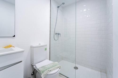 a white bathroom with a shower and a toilet at Wake up with the Sea Breeze- House with pool AP3 in Lavra