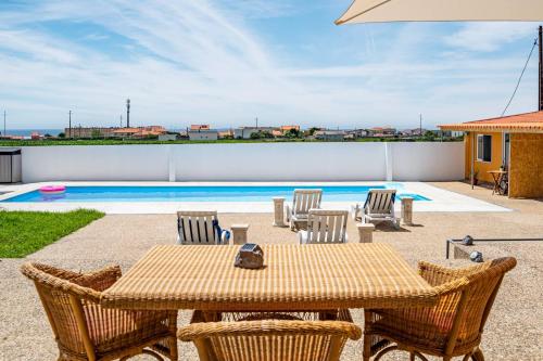 a patio with a table and chairs and a pool at Wake up with the Sea Breeze- House with pool AP3 in Lavra