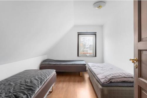 a room with two beds and a window at حورية البحر in Bromölla