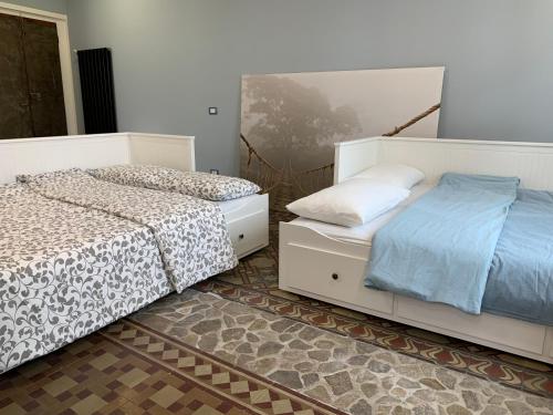 two beds sitting next to each other in a bedroom at La dolce vita in Intra