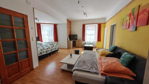 a living room with a couch and a bed at Haus Elena am Semmering in Steinhaus am Semmering