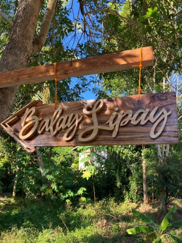 a wooden sign that reads babyappy hanging from a tree at Balay Lipay - Spacious Private House in Siquijor in Siquijor