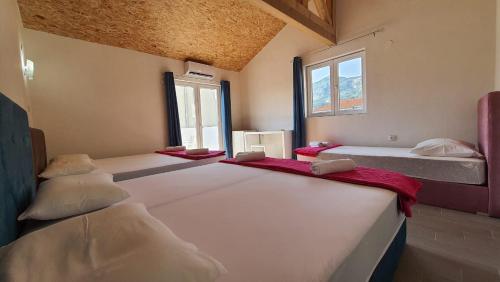 a room with three beds and a window at Adriatic Villa Matea in Budva