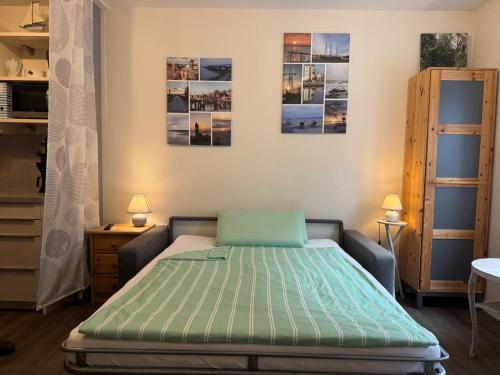 a bedroom with a bed and two pictures on the wall at Gode Wind in Eckernförde