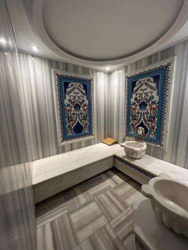 a bathroom with a sink and two mirrors at the Amara Hotel in Istanbul