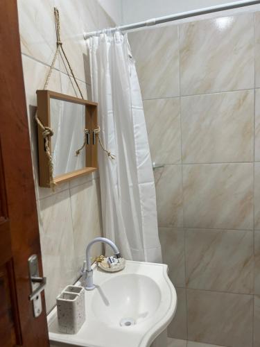 a bathroom with a sink and a shower at Casa Tito in Cascavel