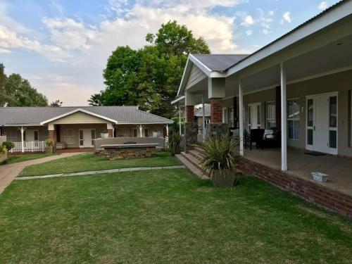 a house with a lawn in front of it at Anathi Hotel in Kokstad