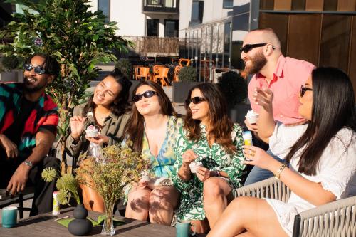 a group of people sitting on a bench at Quality Hotel Hasle Linie in Oslo
