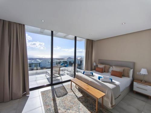 a bedroom with a large bed and a balcony at OCEANIQUE by Buenavilla in Tías