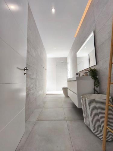 a bathroom with a sink and a toilet in a room at OCEANIQUE by Buenavilla in Tías