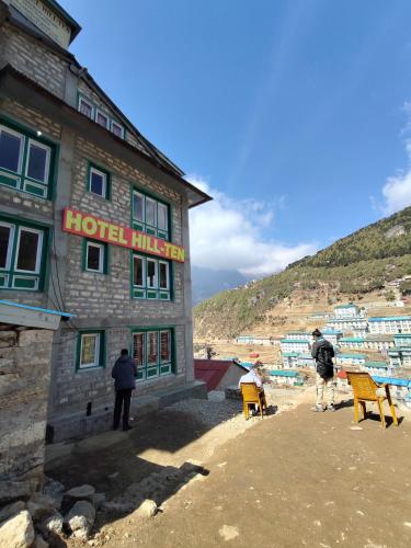 a hotel building with people standing outside of it at Hill-Ten in Namche