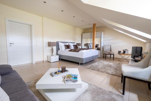 a bedroom with a bed and a living room at Fischerhaus in Moosburg