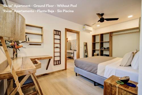 a bedroom with a bed and a room with a desk at Villas Roca del Caribe in Puerto Viejo
