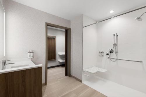 a bathroom with a sink and a shower and a toilet at Holiday Inn Express & Suites Anchorage - Midtown in Anchorage