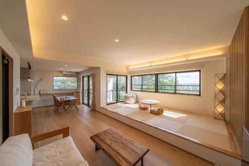 a living room with a couch and a table at LAGUNA OKINAWA Beachfront YAKA in Kin