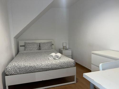 a bedroom with a bed with two towels on it at Taipas Guest House in Porto