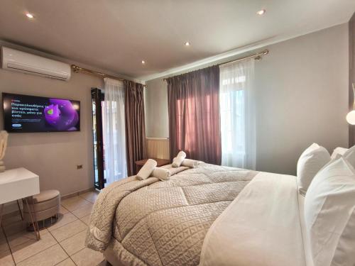 a bedroom with a bed with a teddy bear on it at Meteora Gaia in Kastraki