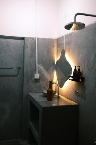 a bathroom with a sink and a light fixture at Fins Arugambay in Arugam Bay