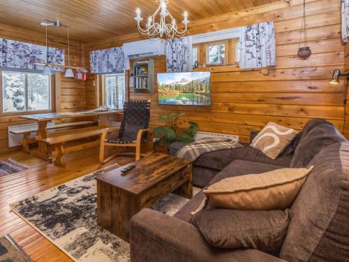 a living room with a couch and a table at Holiday Home Sallanrinne b by Interhome in Salla