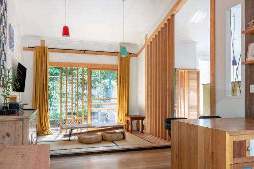 a living room with a table and a large window at Yokomokko House in Bridgewater