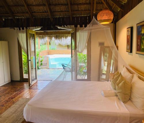 a bedroom with a bed with a view of a pool at Palmeras del valle in La Majagua