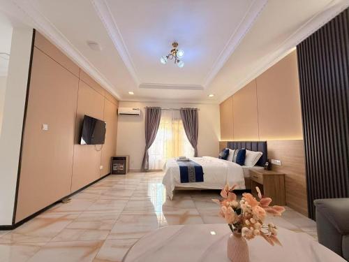 a hotel room with a bed and a television at Star Wish Business Hotel in Lagos