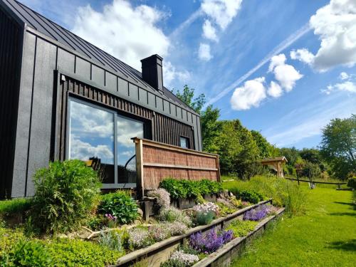 a house with a garden in front of it at Domek Ponad Mgłami in Laskowa