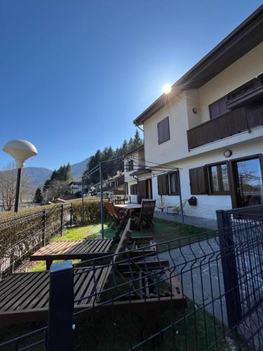 a house with a picnic table on a deck at Cà Serena Panoramic Garden - Appartamento Greta in Ledro
