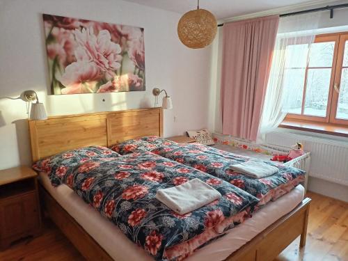a bedroom with a bed with two towels on it at Farma U Nýdrlů in Stará Červená Voda