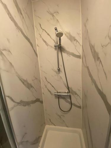 a shower stall with a toilet in a bathroom at Earl's Court Rooms in London