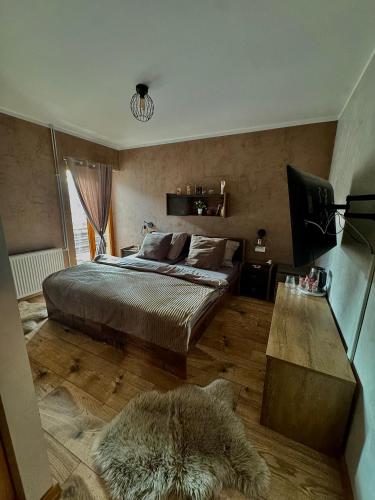 a bedroom with a large bed and a rug at Penzion Bašta in Bílina