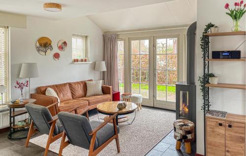 a living room with a couch and a fireplace at Buitengoed Het Lageveld - 56 in Hoge-Hexel