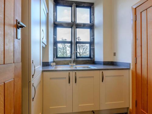 a kitchen with a sink and a window at 3 Bed in Buxton oc-52891 in Sheen